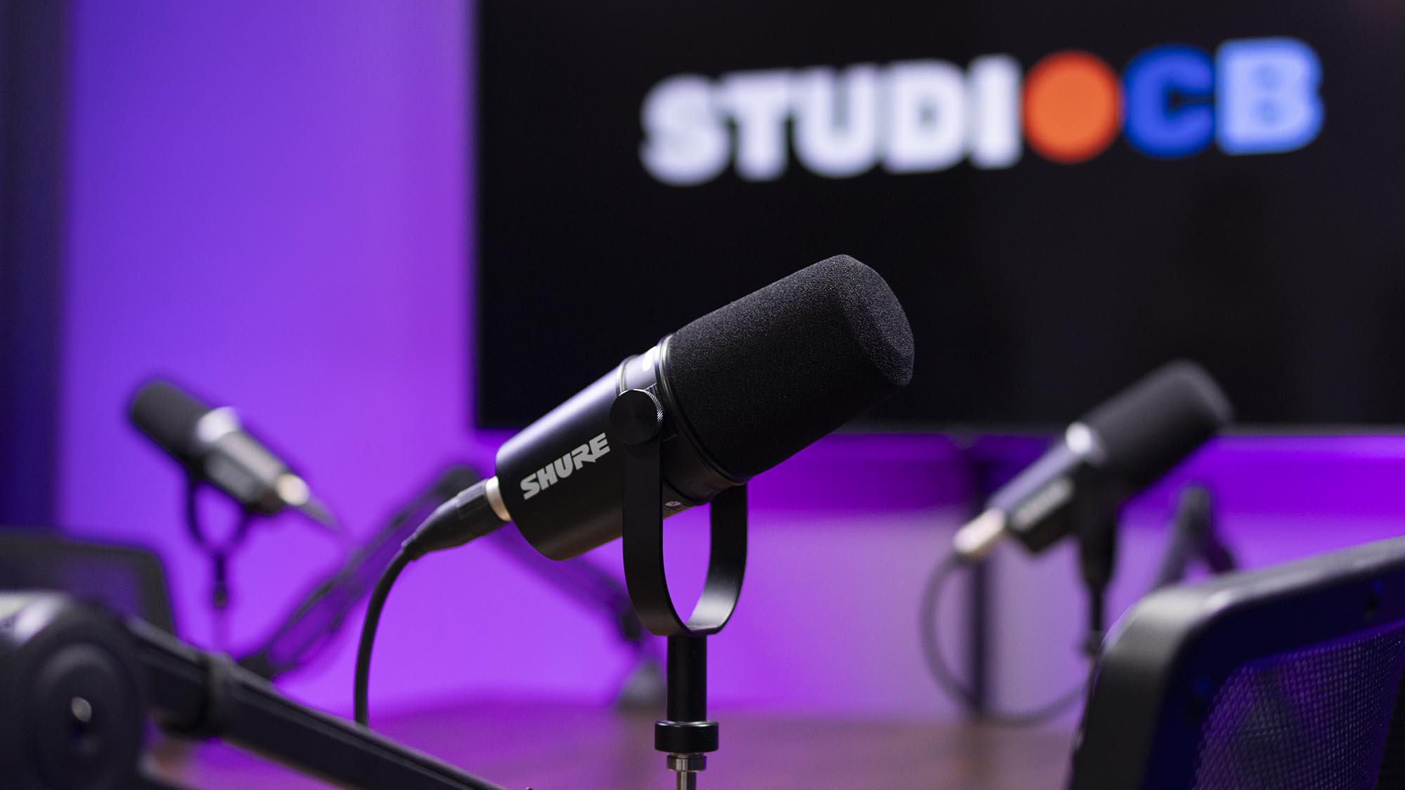 Identidade visual forte: Integre as cores da sua marca na iluminação e logo no telão para vídeos de alta conversão e autoridade.